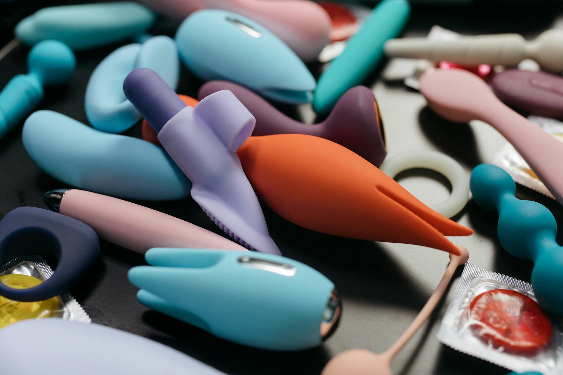 An array of vibrant clitoral vibrators including lemon and traditional models in close-up view.
