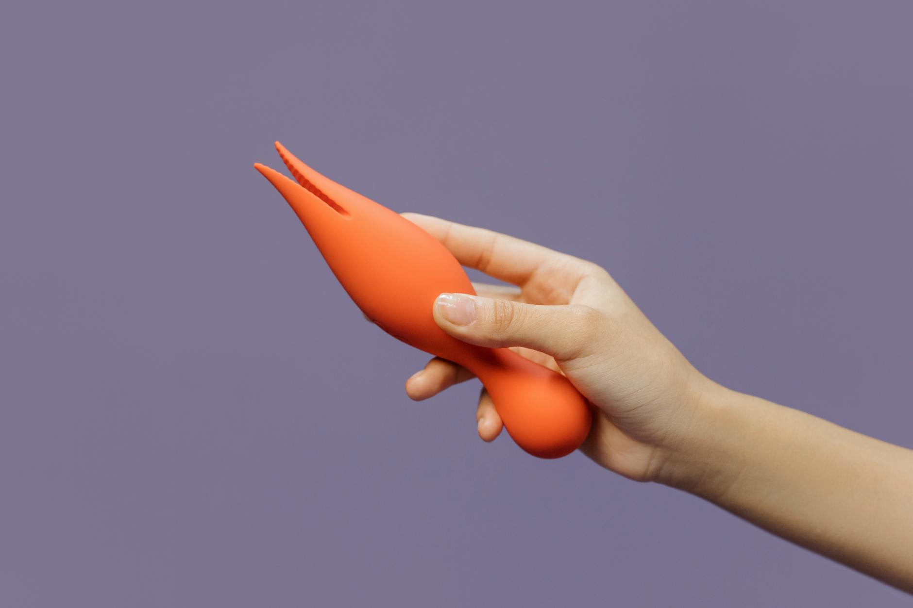 A hand holding a lemon against a vivid yellow background, conveying freshness and sensuality